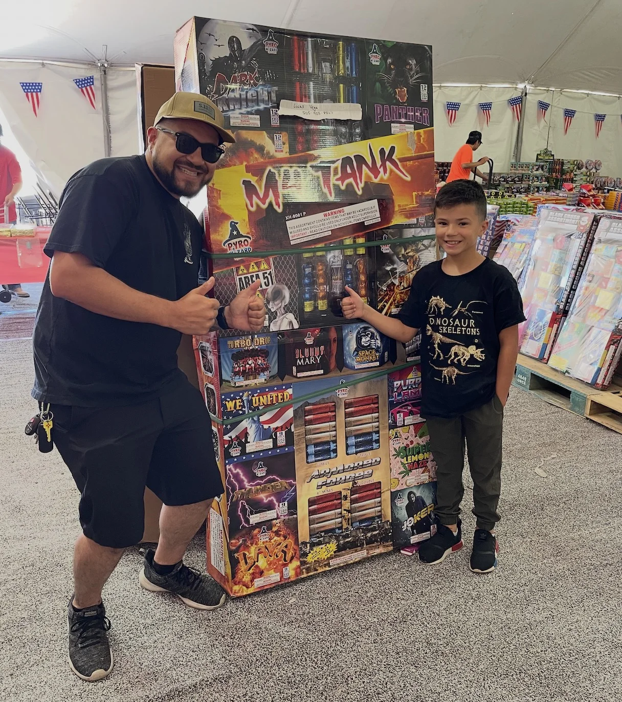 Previous family pack winner with a large fireworks prize pack inside the 1680 Boom tent
